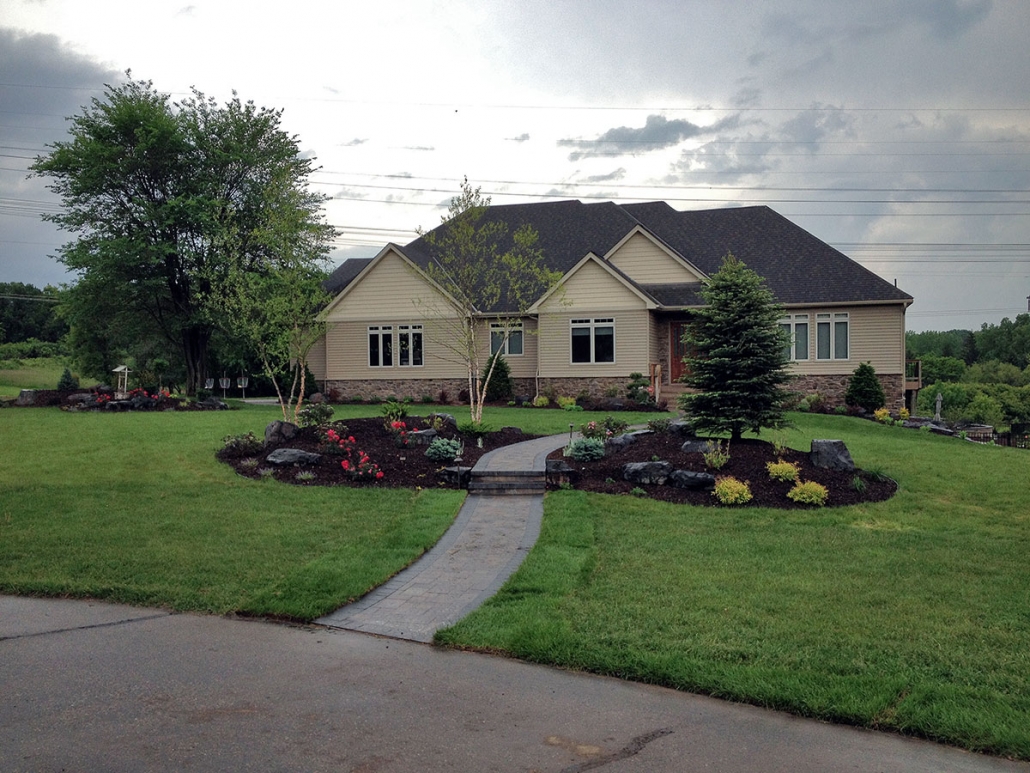 This expanse of green lawn makes these landscape beds pop. 
