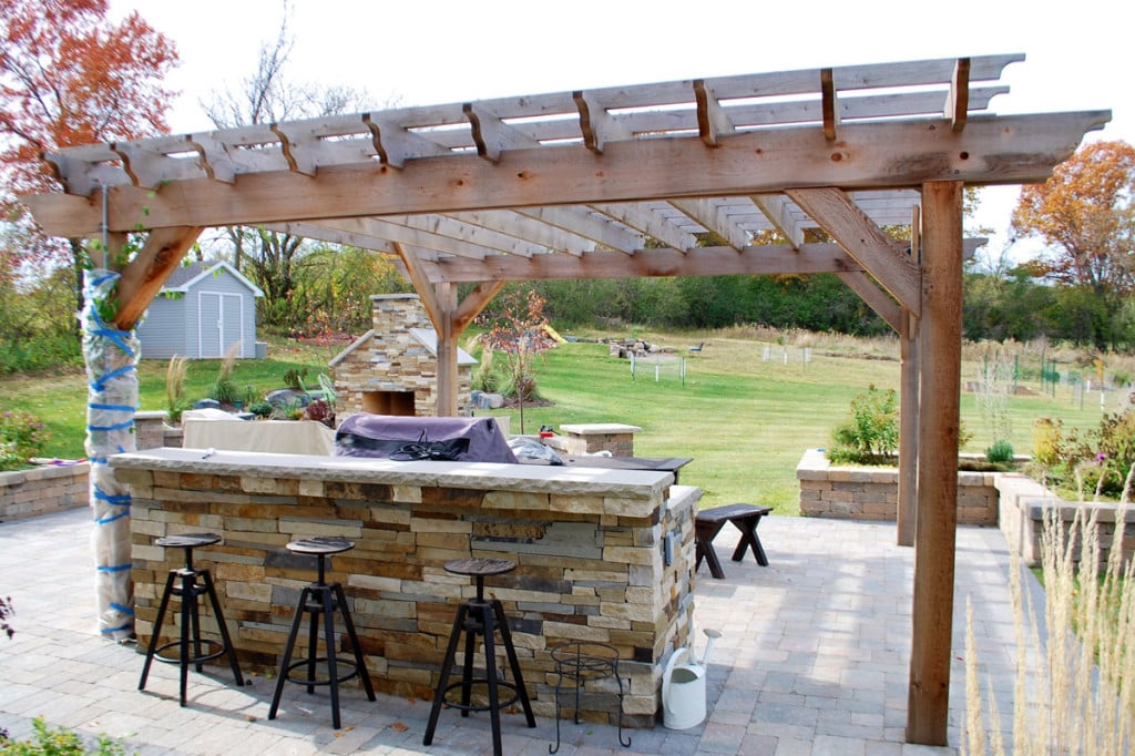 The beams, rafters, and battens on this pergola are all cut in a decorative curved design. 