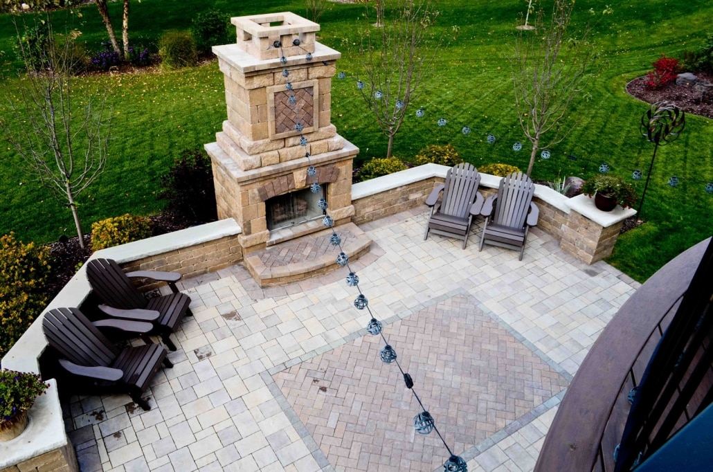 Lights and a Paver 'Rug' add personality to this outdoor fireplace and patio. 