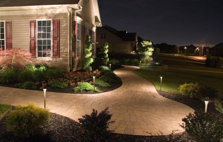 Outdoor landscape lighting on residential walkway and garden