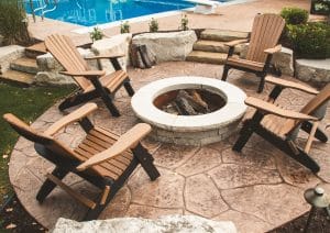 Fire feature fire pit with chairs by pool