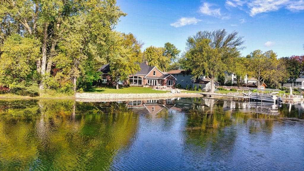 About Us gorgeous house on lake with landscaping
